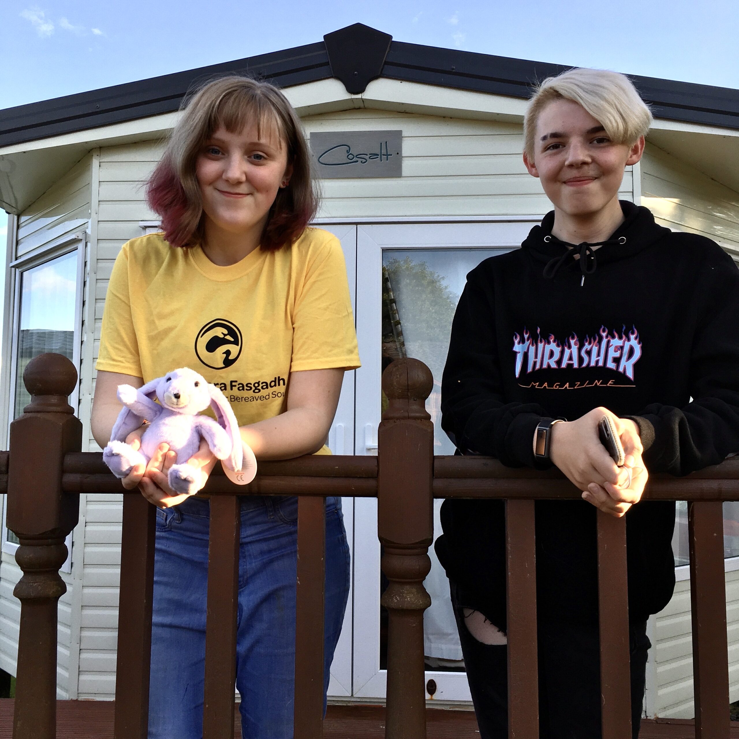Two teenagers outside a holiday caravan