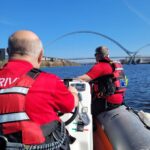 Two men on dingy on river Tees