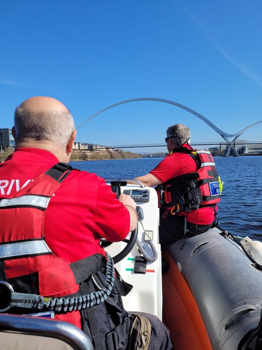 Two men on dingy on river Tees