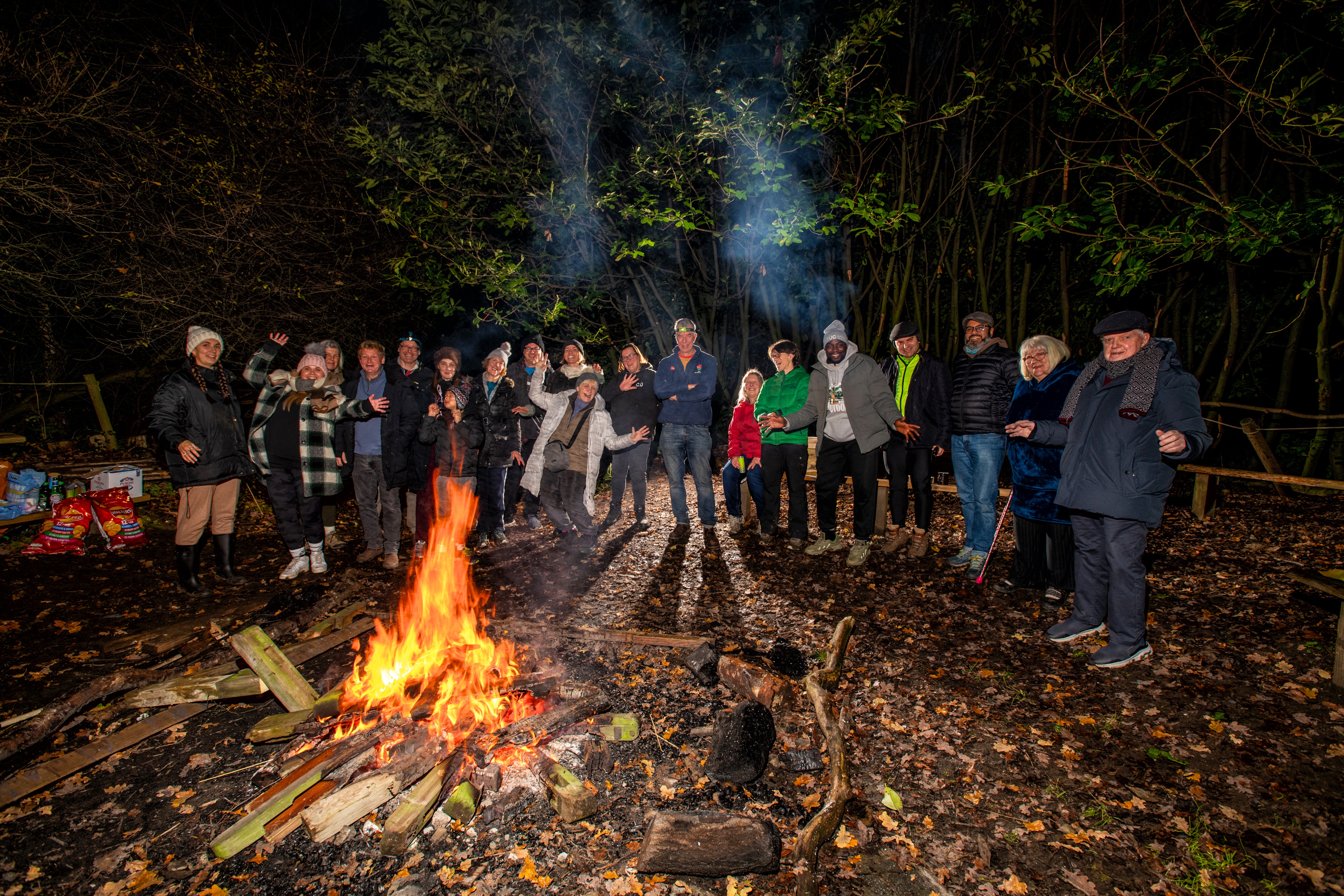 Adults gathered around a bonfire