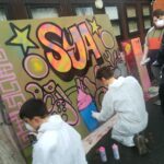 Children spray painting graffitti