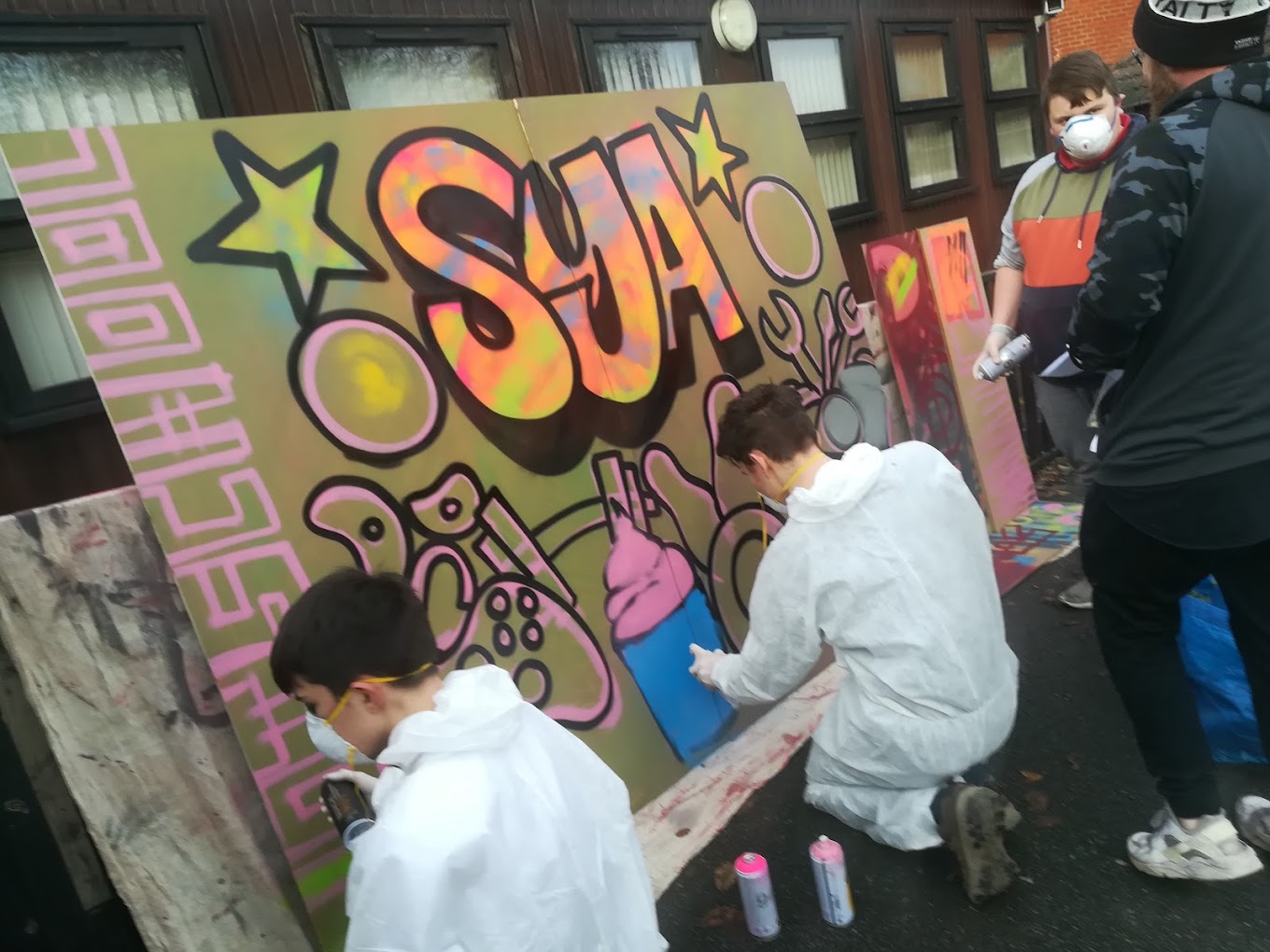 Children spray painting graffitti